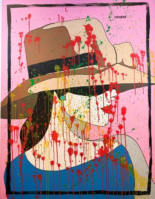 The Woman in the Storm of Color: a woman under a wide-brimmed hat, covered in red splashes, on pink